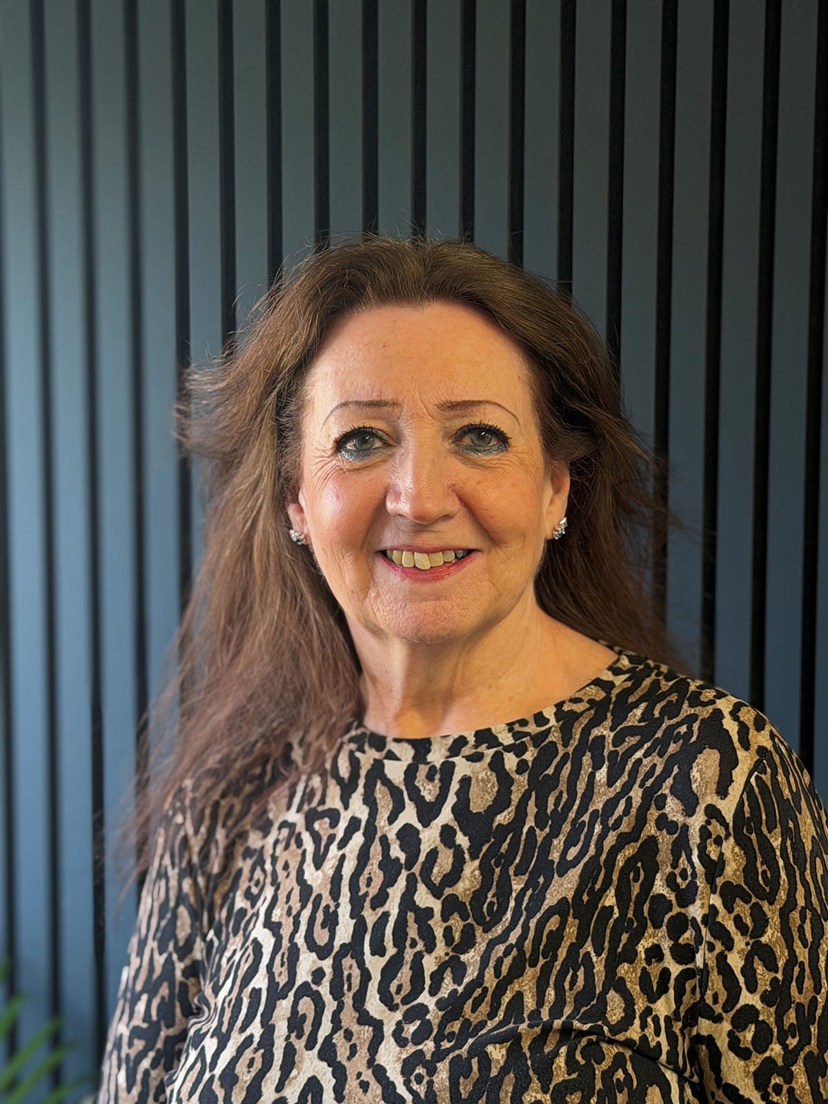 Smiling woman in leopard print top indoors