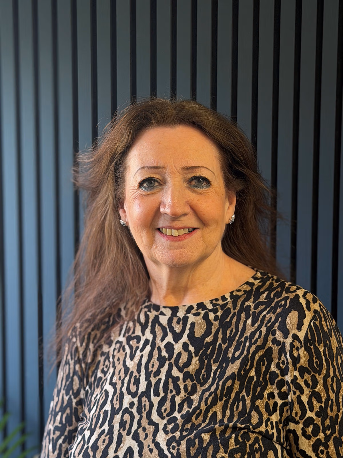 Smiling woman in leopard print top indoors