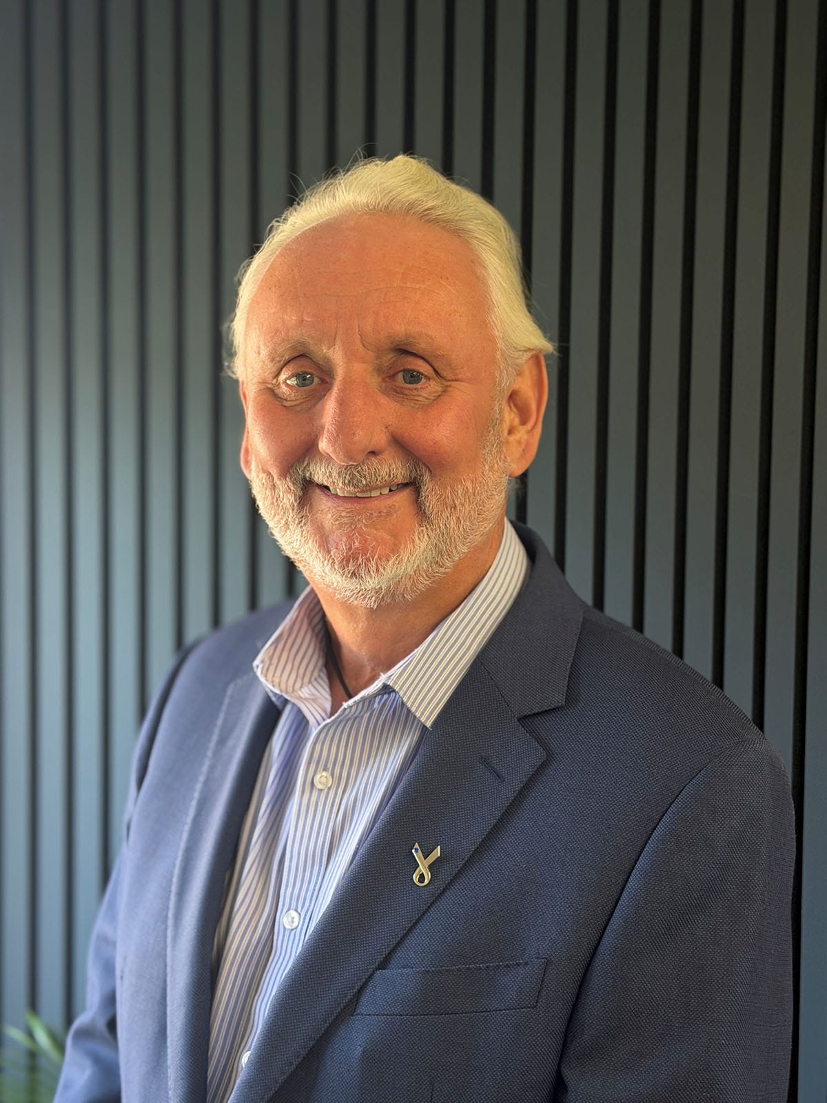 Smiling older man in blue blazer portrait
