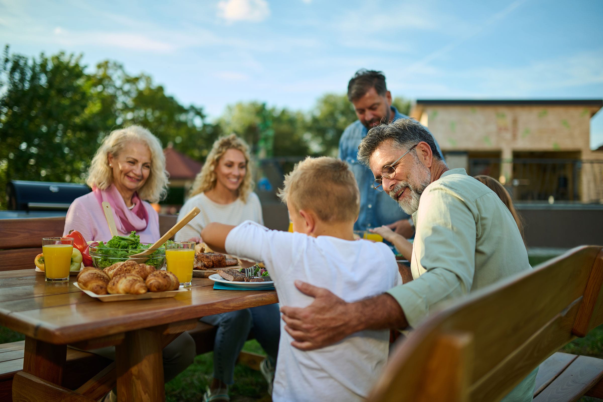 Family enjoying outdoor meal in garden together