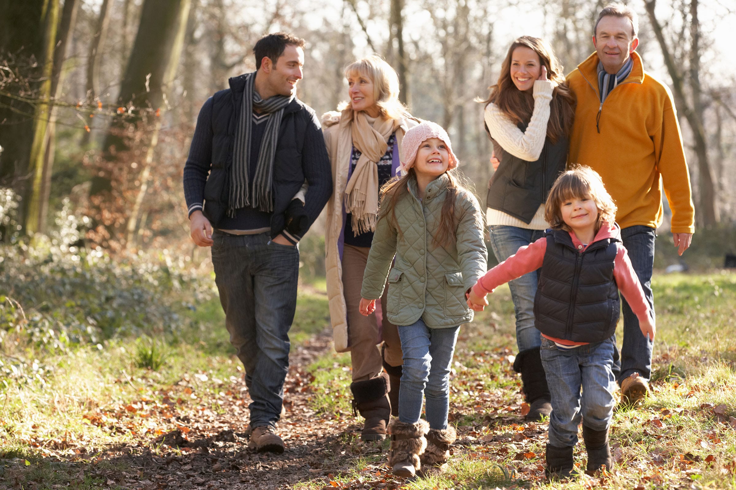 Family walking together in autumn woodland