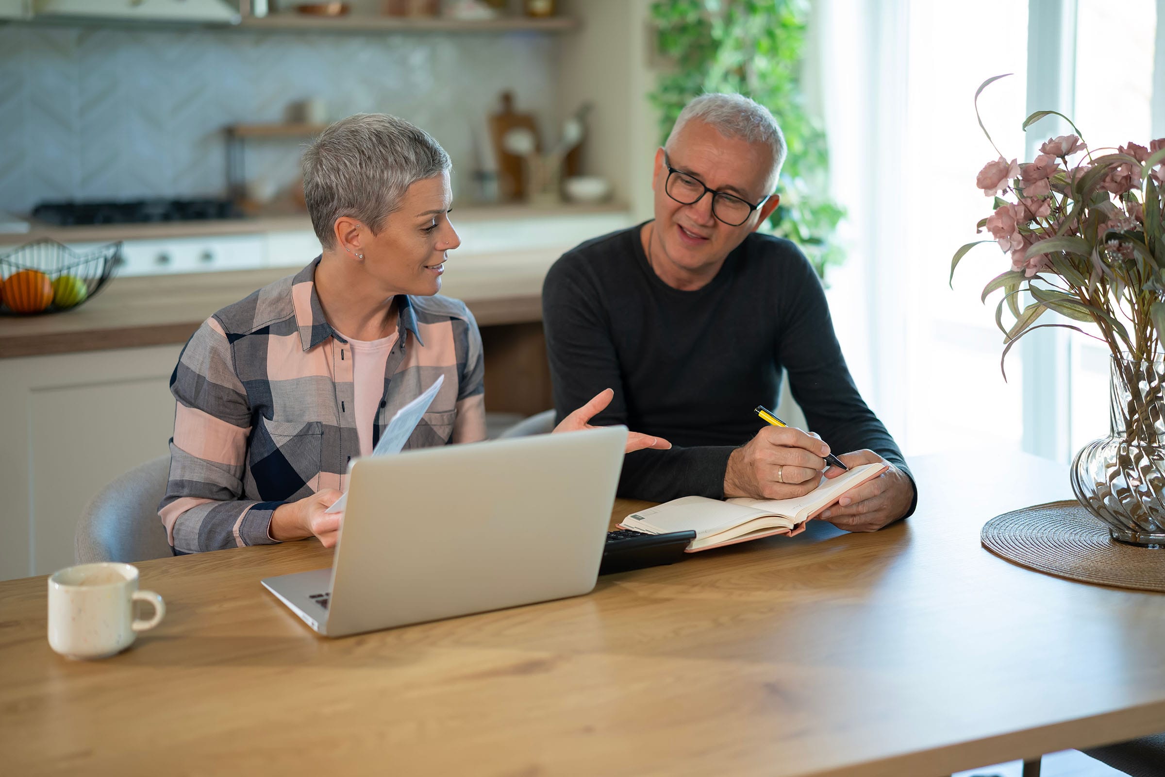 couple at a kitchen table reviewing mortgage paperwork
